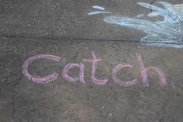Chalk art on a driveway.  The word 