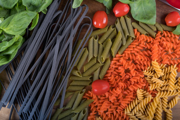 Assortment of different types of gluten-free penne pasta from chickpeas, red lentils, peas