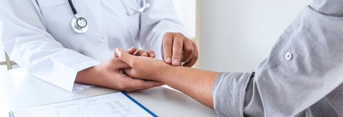 Doctor checking measuring pressure on patient's hand pulse by hands, Medical and healthcare concept