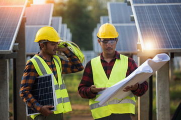 Group of engineers meeting on building roof.solar engineer and electrician checking and resolve problem of generate power in solar power plant