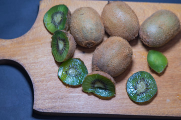 kiwi on wooden board. kiwi on black background
