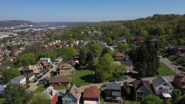 A slowly moving forward aerial establishing shot of a typical Pennsylvanian residential neighborhood. Pittsburgh suburbs. Flown with FAA authorization.  	