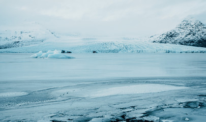 Breathtaking glacier in Iceland with black rock and large ice sheets, melting ice due to climate change