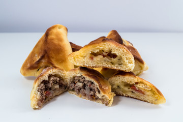 Brazilian snack. Meat Esfiha on white background.