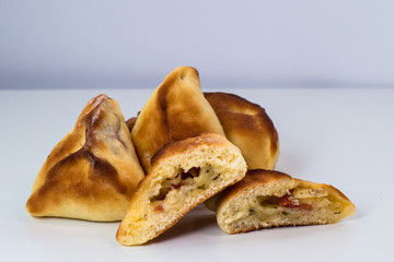 Brazilian snack. Meat Esfiha on white background.