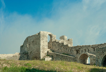 Fototapeta na wymiar Albania - Berat - The strong upper corner tower of ancient Berat castle (aka citadel or fortress) with walls, arches and stairways (built 13 century). Space for text