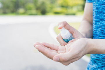 close-up male use alcohol spray to wash hands for protecting coronavirus disease on the road. Concept during the Coronavirus Disease COVID-19.