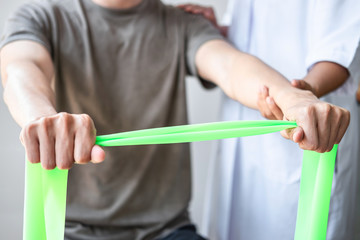 Female Physiotherapist working examining treating injured arm of athlete male patient, stretching and exercise, Doing the Rehabilitation therapy pain in clinic