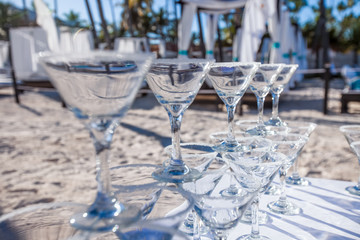 Margarita cocktails, lemonade and champagne sparkling wine glasses on beach outdoor catering event 