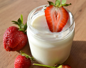 Yogurt with strawberries  on a wooden table. Tasty and healthy breakfast