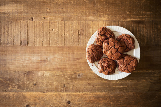 Dark chocolate cookies with macadamia nuts in a rustic environment