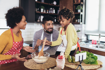 Happy family preparing healthy food in kitchen together