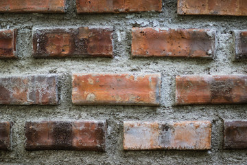 Fototapeta premium Close-up details of a orange-brown brick wall. red brick wall close up, old brick background. red brick wall. vintage style.