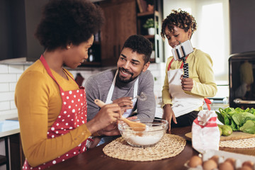 Fototapeta na wymiar Happy family preparing healthy food in kitchen together