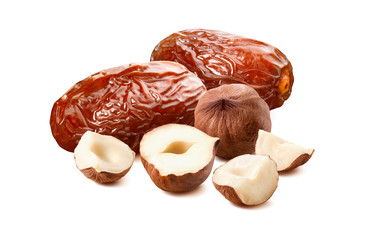 Dates and hazelnuts isolated on white background