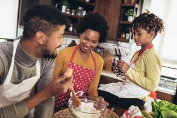 Happy family preparing healthy food in kitchen together