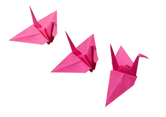 three pink origami birds on white