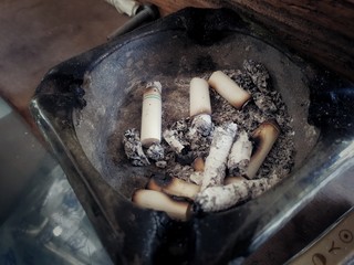 smoked cigarette butts in ashtray
