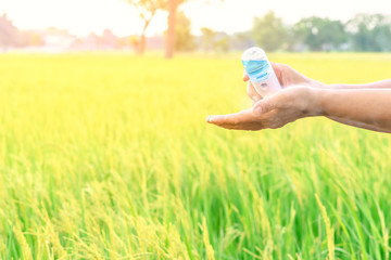 Woman using alcohol nano mist sprayer antiseptic cleaning on her hands protection during...