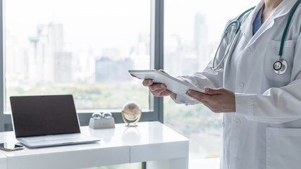 Telemedicine by medical doctor or physician consulting patient’s health telehealth online using mobile tablet in hospital for professional digital emergency tele-healthcare assistance service