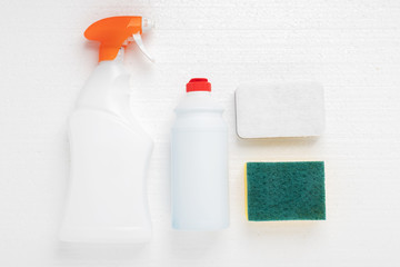 Cleanliness and hygiene in the house. Sponges and cleaning agent for plumbing, sinks, bathtubs, toilet bowls in bottles on a white background