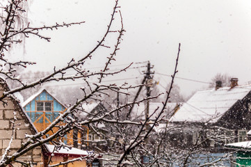 In the countryside, snow falls, the view from the window.