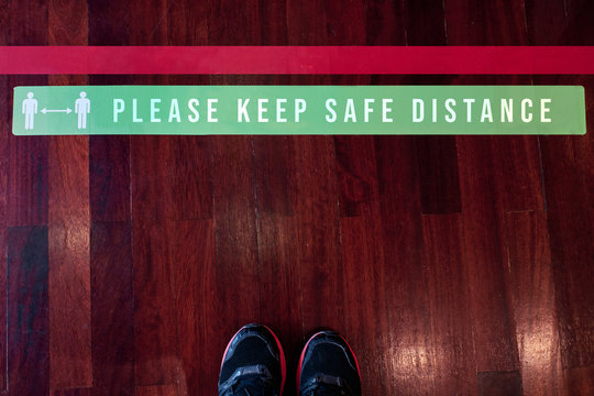 Please keep safe distance sign on the floor during coronavirus outbreak - social distancing concept