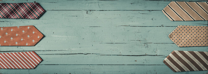 Double border of ties on a light green wooden background