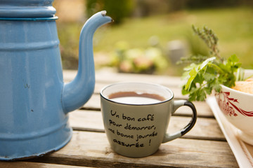 Tea from vintage teapot, pour into mug. Provence.