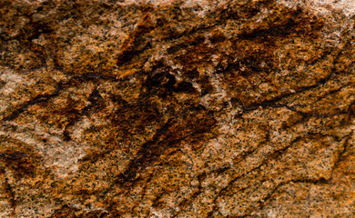 Yellow-Brown granite. Granite rocks. Rusted background. Colorful Rock background. Rock wall backdrop with rough red brown texture. Grunge Abstract Stone Surface.	