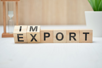 The concept of export and import on wooden cubes.