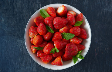 strawberries on a dark wooden surface