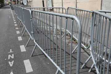 Stack of metal fences in by a street Concept big public event preparation and crowd and safety control.