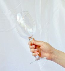 Female hand holds a glass with orange juice