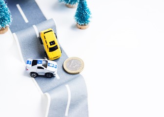 Cars accident on rough road. Two toy models on duct tape. Slippery or rough road.
