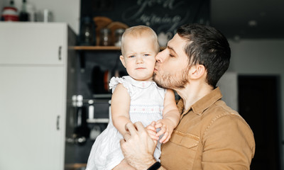 Father's day. Man father kisses his little daughter.