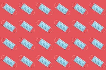 COVID-19 disposable surgical face mask on red background. Protection against coronavirus. Healthcare and medical concept. Seamless medical pattern
