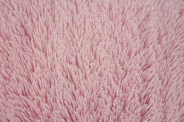 Close-up pink, soft, fluffy wool with long pile.  Faux fur texture,  background.