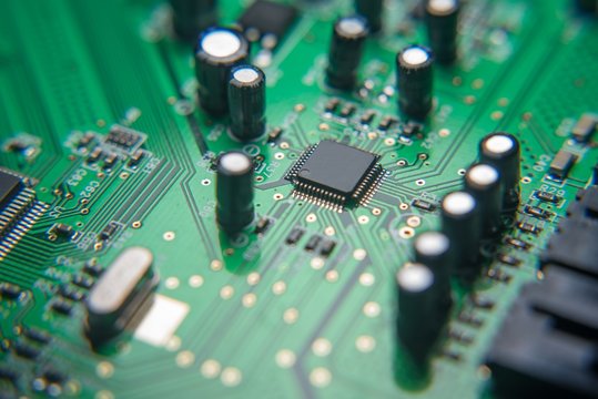 Electronic card-board with some components. Focus. Blured. Macro photo. Zoom. Liitle. Big. Enhanced circuits.