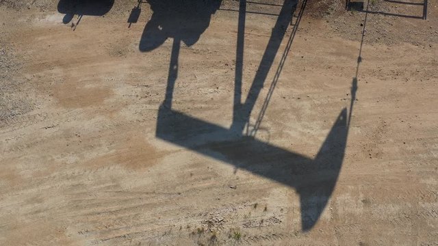 Shadow of an oil well pump jack, Burleson County, Texas, USA