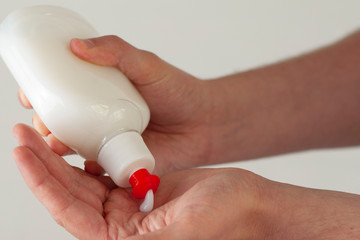 Liquid soap pours into the hands of man.