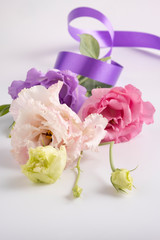 Small bouquet of delicate eustoma on a white background.