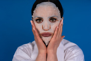 Girl makes herself a cosmetic procedure on their own at home, mask for face, concept of skin care