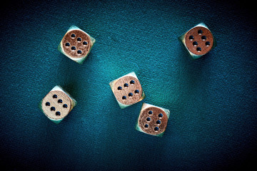 Gambler threw jackpot on casino dice on the green poker table in the las vegas. Golden chips and...