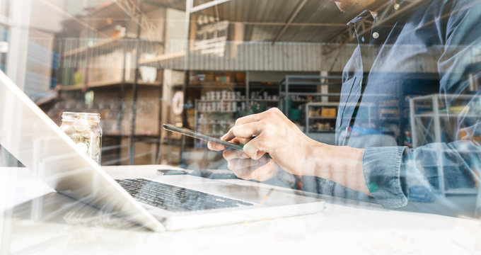 Businesswomen hands working with finances about cost and calculator and laptop with tablet, smartphone at office in morning light