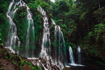 Fototapeta na wymiar Cascade waterfalls in tropical rain forest at Bali