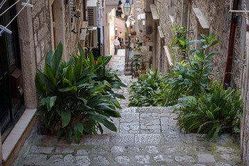 Fototapeta na wymiar Narrow and steep street in Dubrovnik, formerly Ragusa, city located on the Dalmatian coast, Croatia, Europe