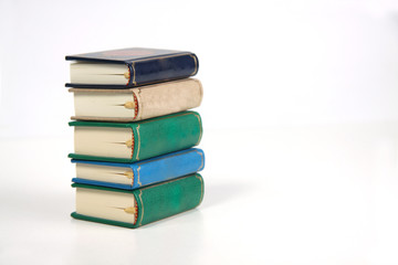 vertical pile of books isolated on white background. Image contains copy space