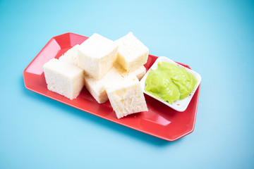 Red square dish with bread and.steamed green custard