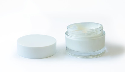 cosmetic glass jar with cream on a white, brown background and with an open lid, copy pace isolate, closeup